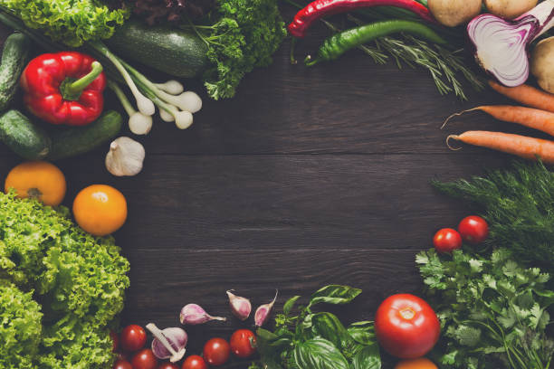 istock Frame of fresh vegetables on wooden background with copy space 871996396