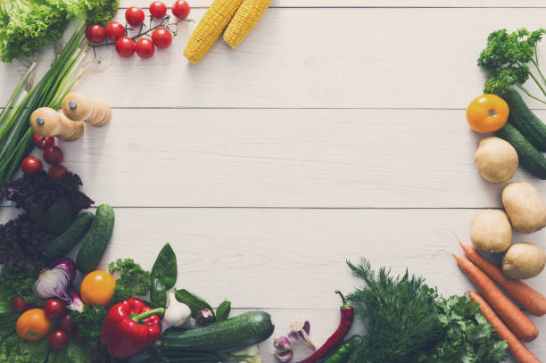istock Border of fresh vegetables on white wood background with copy space 871996638