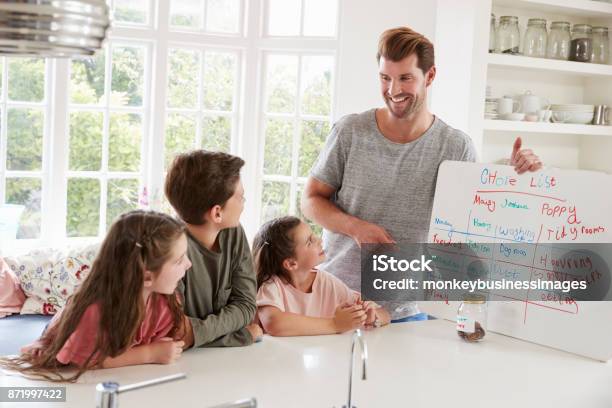 Children Receiving Pocket Money After Completing List Of Chores Stock Photo - Download Image Now