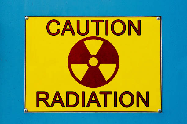 Closeup view of caution of radiation sign. Yellow board on blue metallic surface