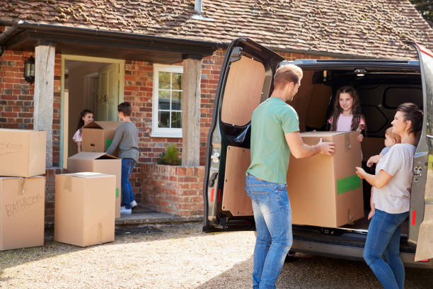 istock Family Unloading Boxes From Removal Truck On Moving Day 872001882