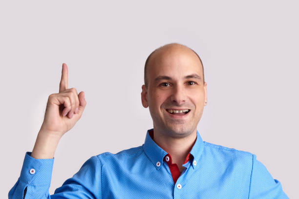 istock man pointing his finger up to copy space 872005698
