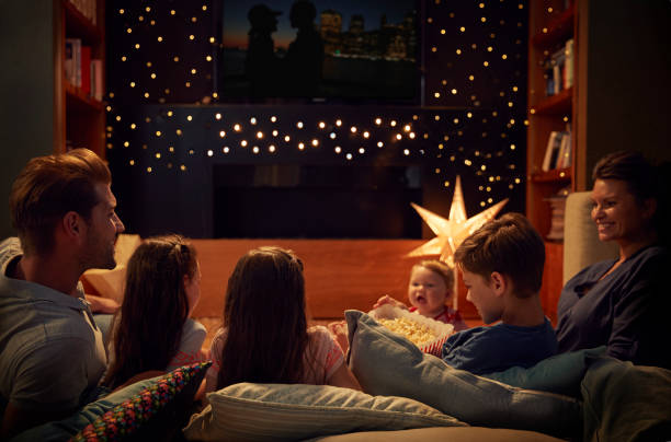 Family Enjoying Movie Night At Home Together Family Enjoying Movie Night At Home Together 6 11 months stock pictures, royalty-free photos & images