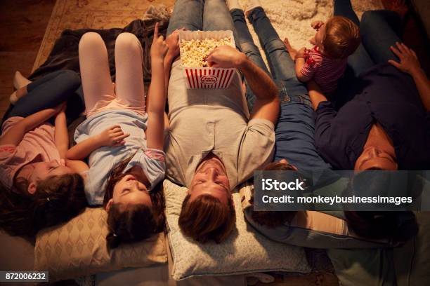 Overhead View Of Family Enjoying Movie Night At Home Together Stock Photo - Download Image Now