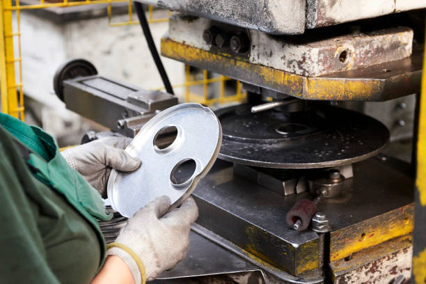 istock Inside a factory, industrial worker in action on metal machine 872016754