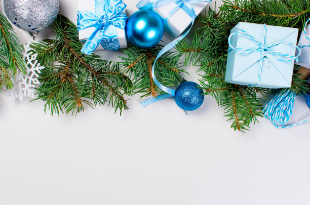 istock blue and white Gift boxes tied with a ribbon , fir branches, 872017732