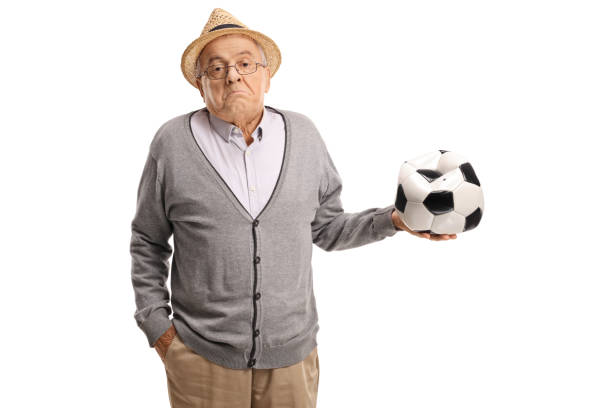 istock Disappointed mature man holding a deflated football 872017906