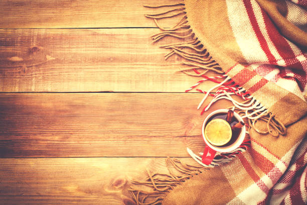 istock Red cup of hot tea with lemon and cinnamon. 872018630