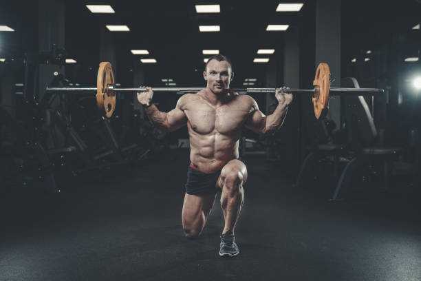 istock Handsome model young man training legs in gym 872024106