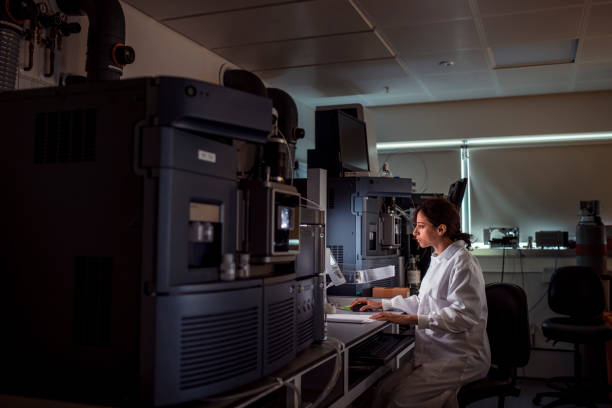 Female Medical Analyist Patient personal health care taken by a specialist biochemist in a London research facility biochemist stock pictures, royalty-free photos & images