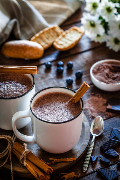 istock Two homemade hot chocolate mugs on rustic wooden table 872026664