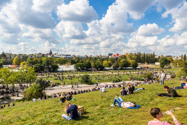 Berlin: People enjoy sunny Sunday at Mauerpark. Situated in “death strip” of Berlin Wall (Mauer) Mauerpark is now a social, cultural and artistic center of Berlin