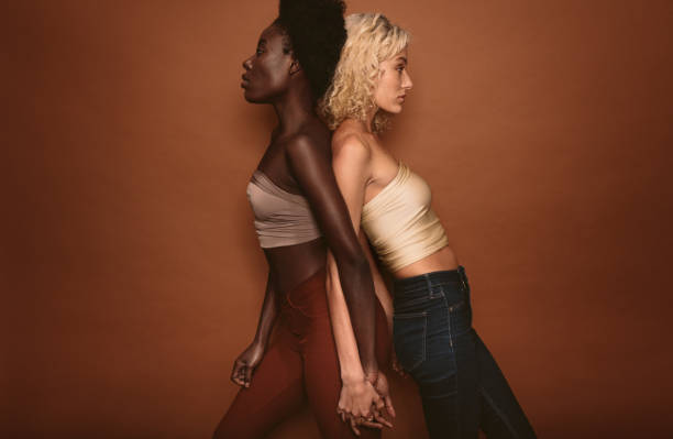 istock Diverse females standing on brown background 872034060