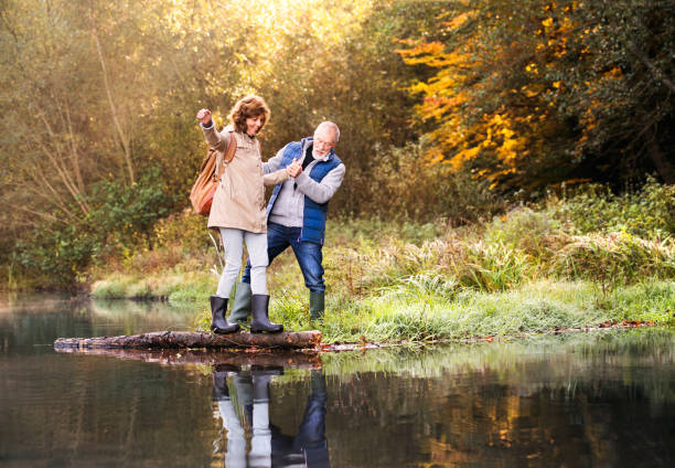istock Senior couple on a walk in autumn nature. 872034312