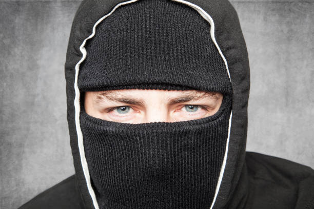 istock Close-up on man in balaclava, suspicious type 872034358