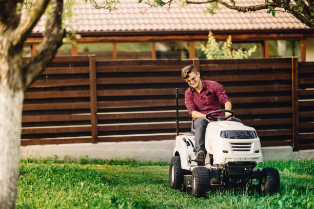 istock worker gardening and doing landscaping works, using professional tools and machinery 872037672