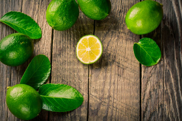 istock Juicy lime on a wooden background 872038254