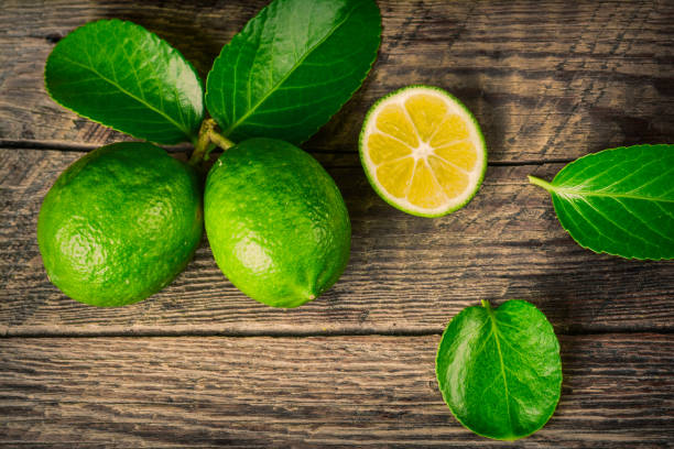 istock Juicy lime on a wooden background 872038300