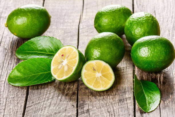 istock Juicy lime on a wooden background 872041814