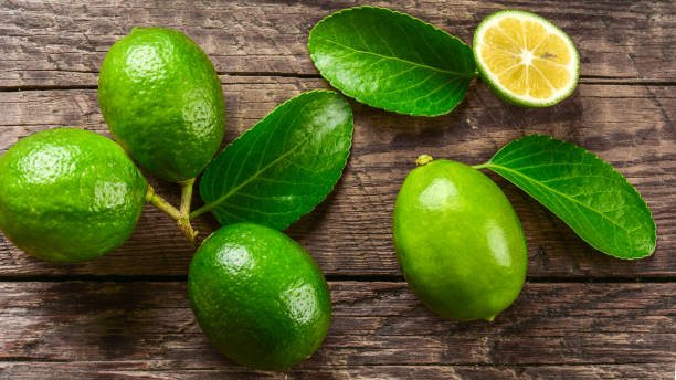istock Juicy lime on a wooden background 872041914
