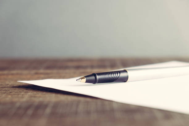 pen and paper on wood background with filter effect retro vintage style