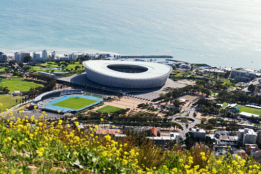 Cape Town, South Africa - September 14, 2017: High angle view on the beautiful coastline and the modern building of the Cape Town Stadium, built for the 2010 FIFA World Cup. View from Signal Hill.