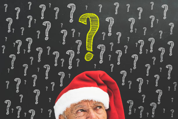 istock Senior man with red Santa hat in front of blackboard 872049466
