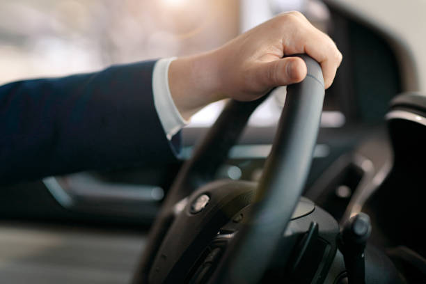 istock Male hand on a steering wheel 872050250