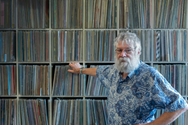 istock Record collector with beard in front of his collection. looking at camera 872062656