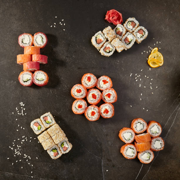 istock Set of sushi rolls on black background 872066400