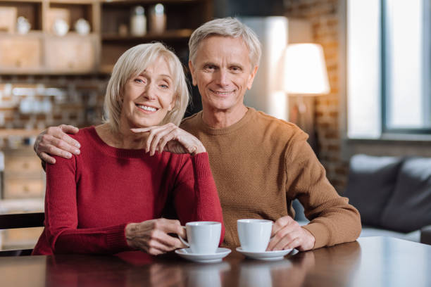 istock Cheerful senior people smiling while sitting together 872071388