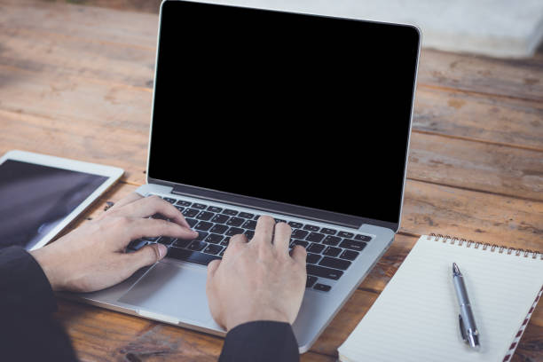 istock Businessman using laptop working with tablet vintage tone. 872071412