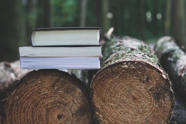 istock A stack of books lying on the logs,  save trees - read ebooks concept 872071684