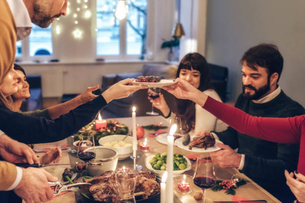 istock friends eating festive meal at christmas table 872071706
