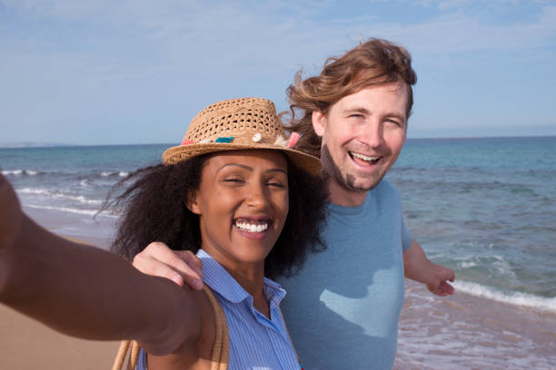 istock Couple taking selfie on the beach. 872076626