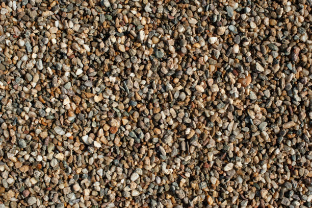 istock Small and big sand, gravel and pebbles background pattern 872086092