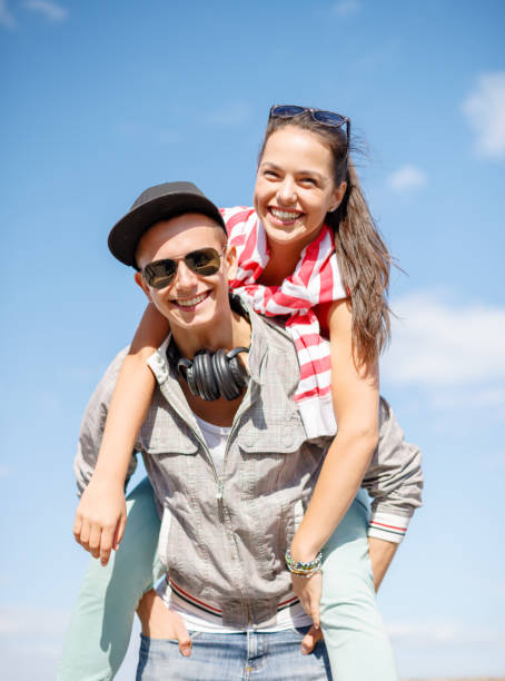 istock smiling teenagers in sunglasses having fun outside 872086334
