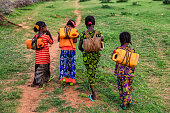 African girls carrying water from the well, Ethiopia, Africa