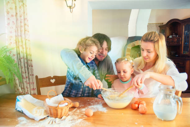 istock Family Preparing a Cake Together 872092882