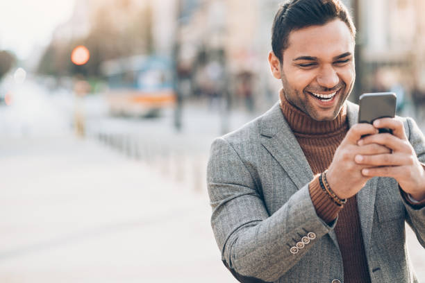 istock Happy businessman with smart phone 872104904