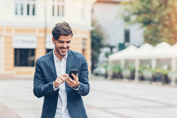 istock Young man texting on the street 872104924