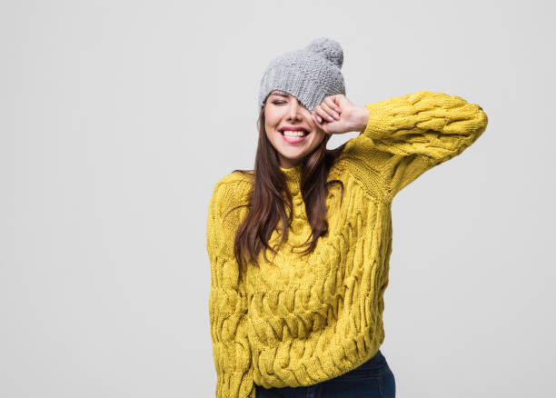 Beautiful woman winter portrait Beautiful joyful girl is laughing and having fun. Studio shot. Isolated on gray background winter fashion stock pictures, royalty-free photos & images