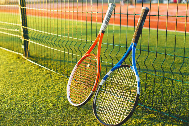 istock Tennis rackets on grass 872108066