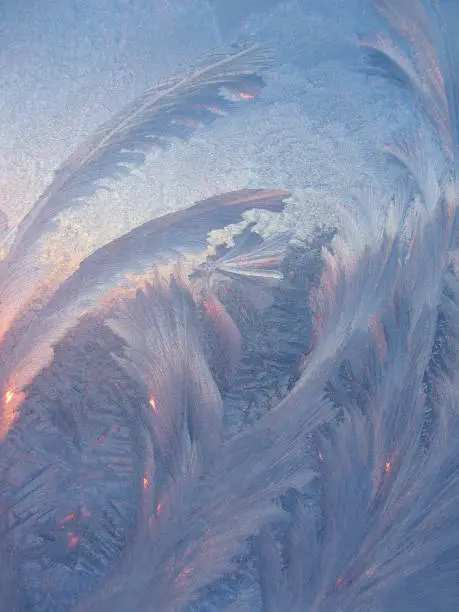 Ice pattern with sunlight on winter glass, natural texture