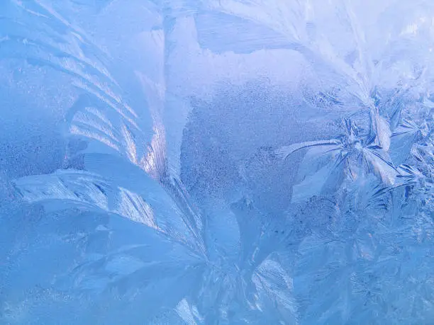 Natural ice pattern on winter glass, close-up texture