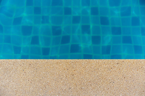 istock Pattern in under swimming blue pool background and floor small granite stone. 872115242