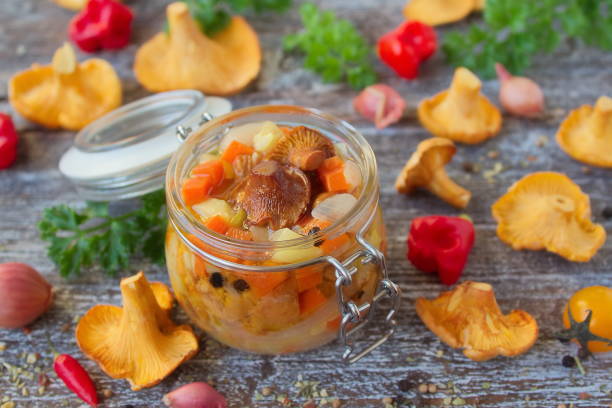 vegetables and mushrooms chanterelles in a glass jar vegetables and mushrooms chanterelles in a glass jar, the preserves in the marinade Cepe stock pictures, royalty-free photos & images