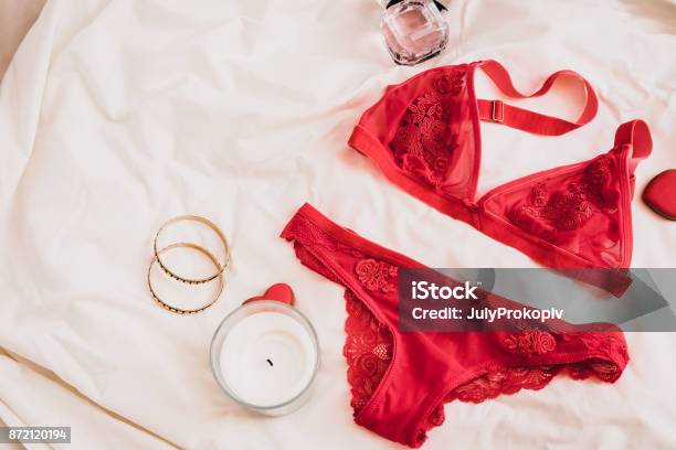 Womans Lingerie On White Bed Sheets Flatlay Stock Photo - Download Image Now - Lingerie, Red, Underwear