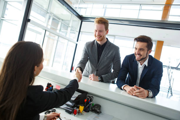 istock Receptionist welcoming and shaking hands with a visiting businessman 872120236