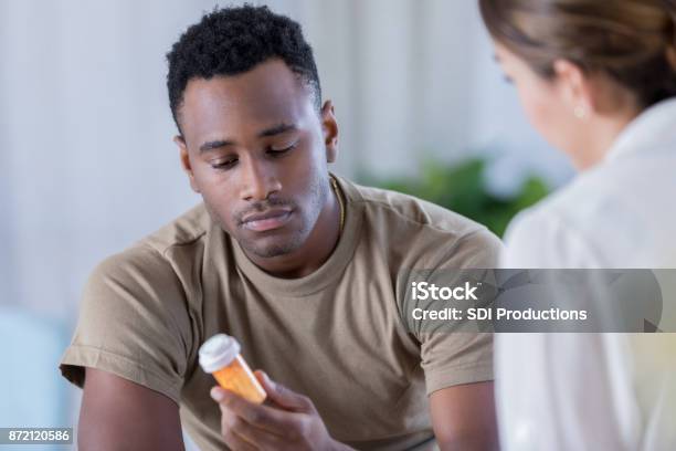 Young Military Officer Receives Medication For Depression Stock Photo - Download Image Now
